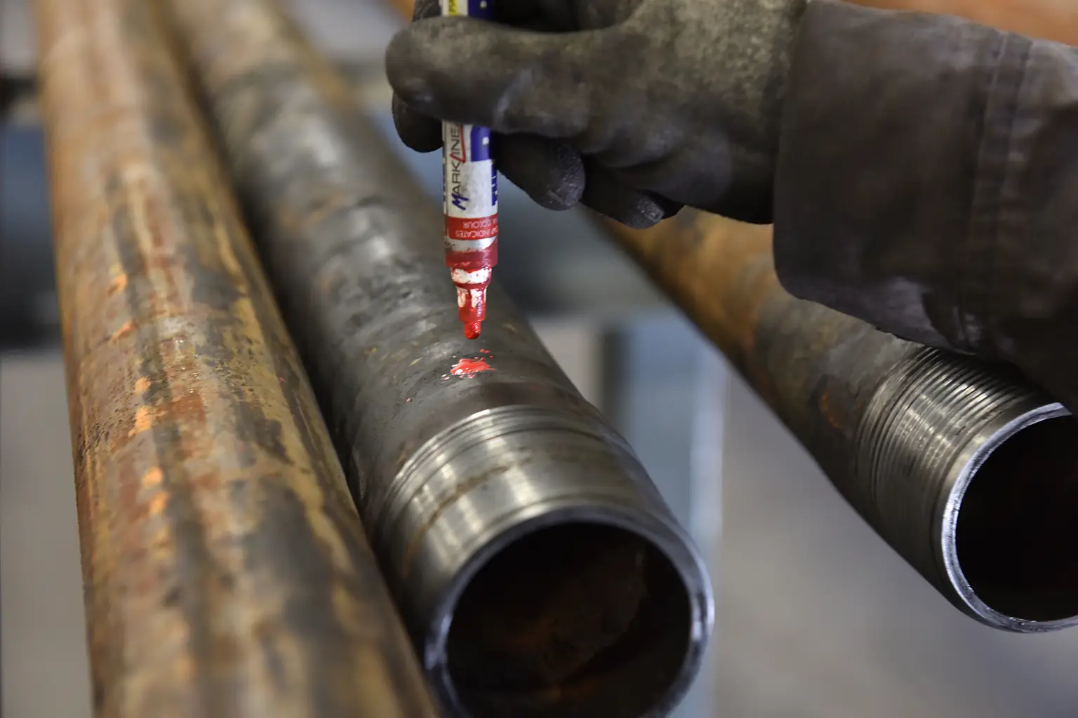 Force Inspection Services OCTG services Red markers making a mark on a pipe