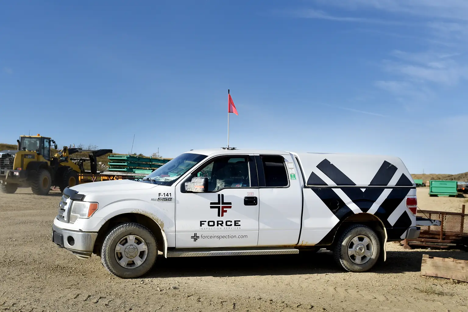 Force Inspection Services Out of town services white truck on a construction site